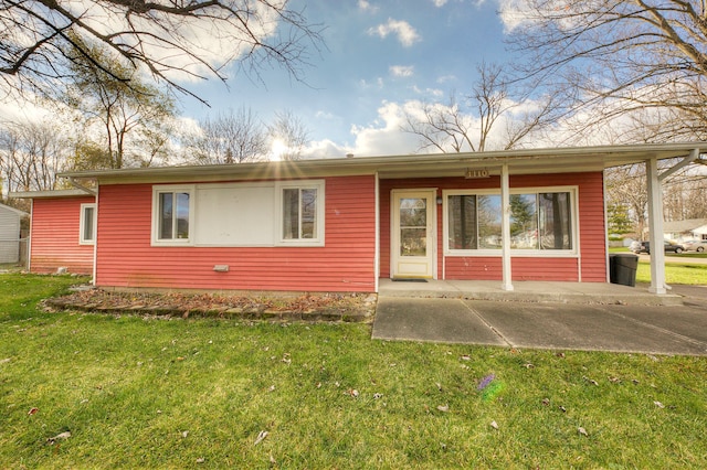 rear view of property with a yard