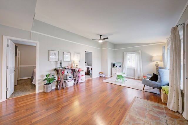 sitting room with hardwood / wood-style floors, ceiling fan, and lofted ceiling