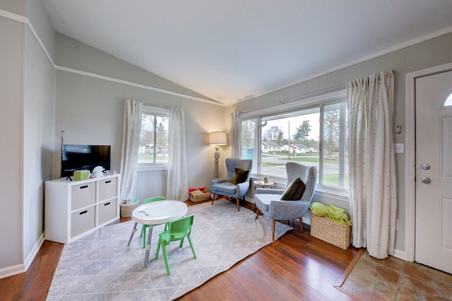 sitting room with hardwood / wood-style flooring and vaulted ceiling