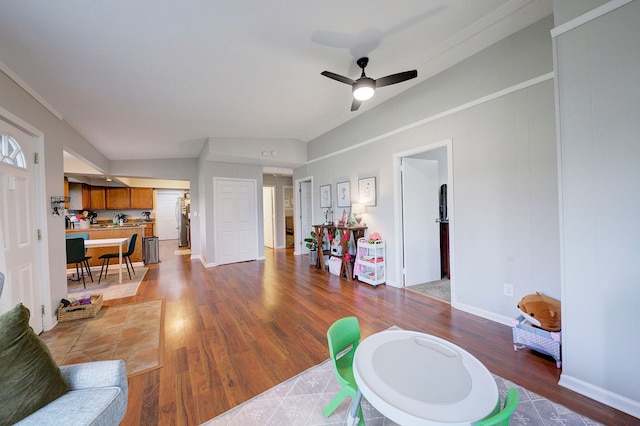 living room featuring hardwood / wood-style floors, ceiling fan, and lofted ceiling