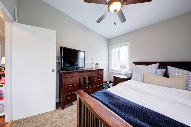 bedroom with ceiling fan, light carpet, and vaulted ceiling