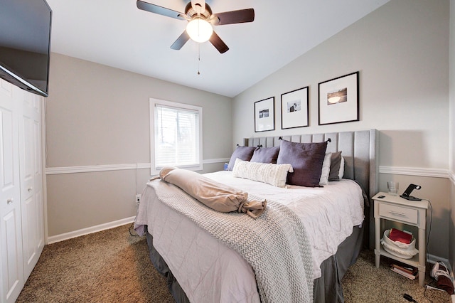 bedroom featuring dark colored carpet, ceiling fan, lofted ceiling, and a closet