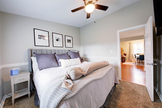 bedroom with ceiling fan and dark carpet