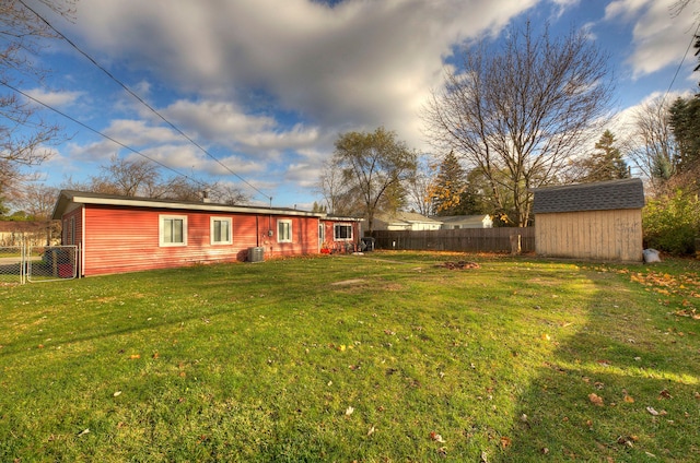 view of yard featuring a storage shed and central air condition unit