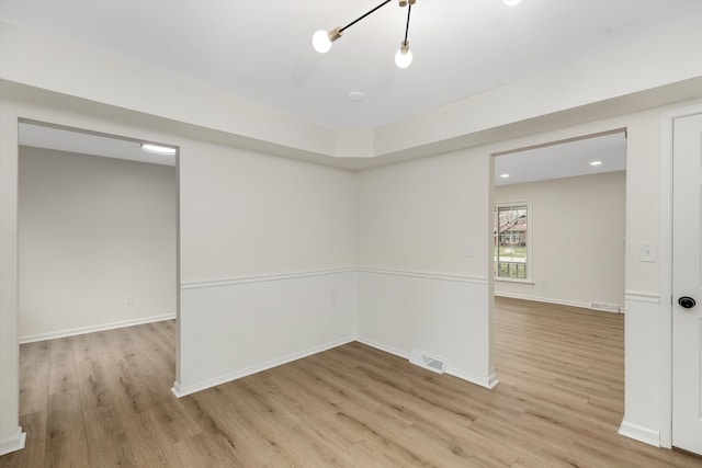 unfurnished room with light wood-type flooring