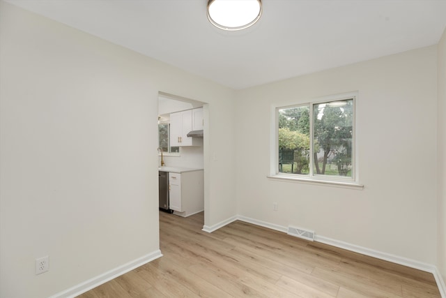 empty room with light hardwood / wood-style flooring