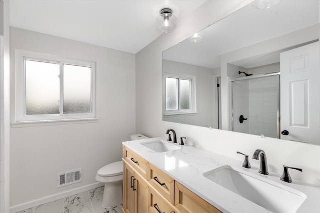 bathroom with a shower with door, vanity, and toilet