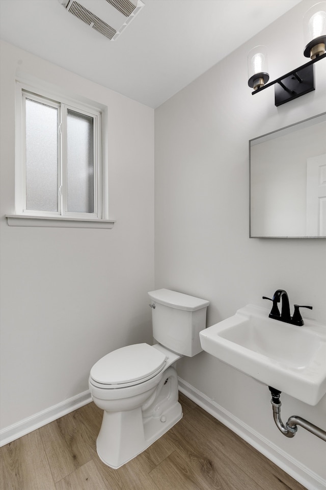 bathroom featuring hardwood / wood-style floors, toilet, and sink