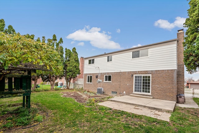 back of house featuring a lawn, a gazebo, a patio, and central AC