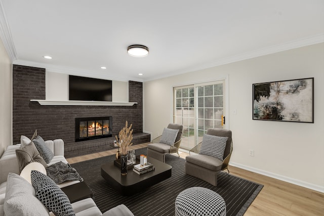 living room featuring a fireplace, hardwood / wood-style flooring, and crown molding