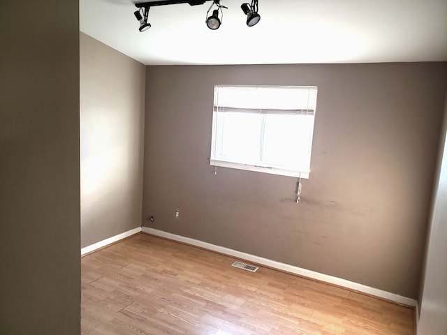 empty room featuring light hardwood / wood-style floors and lofted ceiling