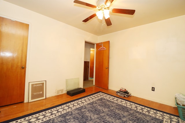 empty room with hardwood / wood-style floors and ceiling fan