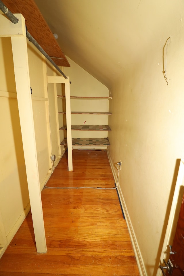 interior space with hardwood / wood-style flooring and lofted ceiling