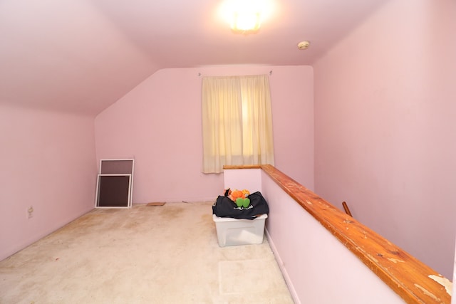 bonus room featuring light colored carpet and lofted ceiling