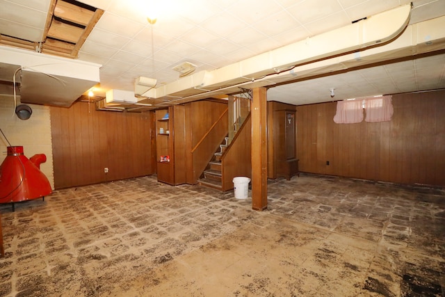 basement featuring wooden walls