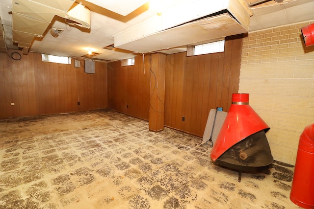 basement with brick wall and wooden walls