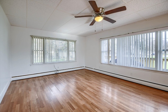 empty room with plenty of natural light and light hardwood / wood-style floors