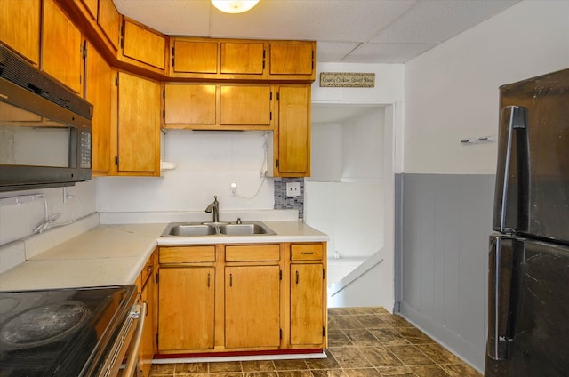 kitchen featuring backsplash, sink, a drop ceiling, and appliances with stainless steel finishes