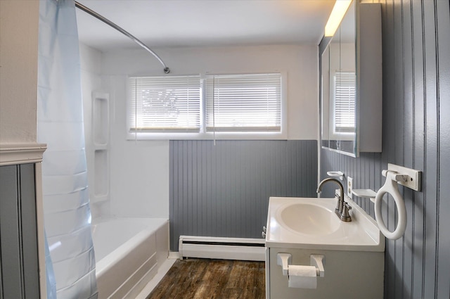 bathroom featuring baseboard heating, vanity, shower / bathtub combination with curtain, and wood-type flooring