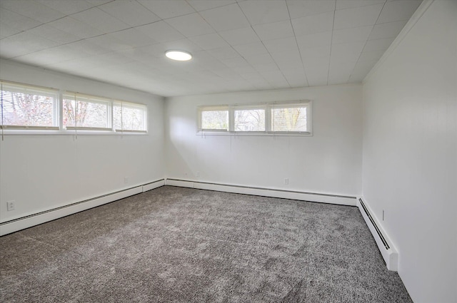 carpeted spare room featuring a baseboard radiator