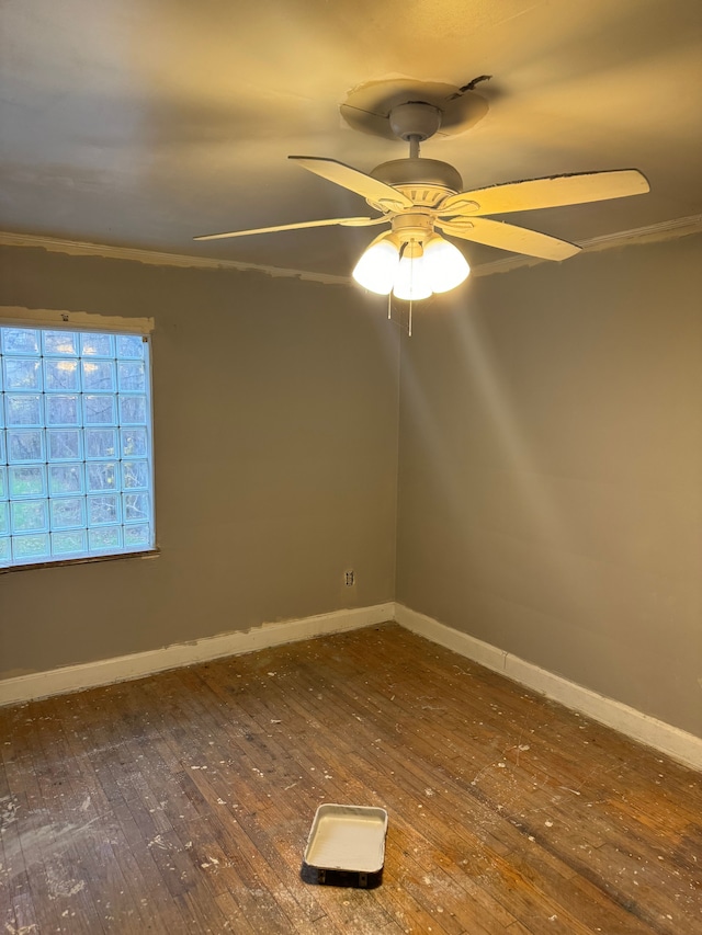 spare room with dark hardwood / wood-style flooring, ceiling fan, and crown molding