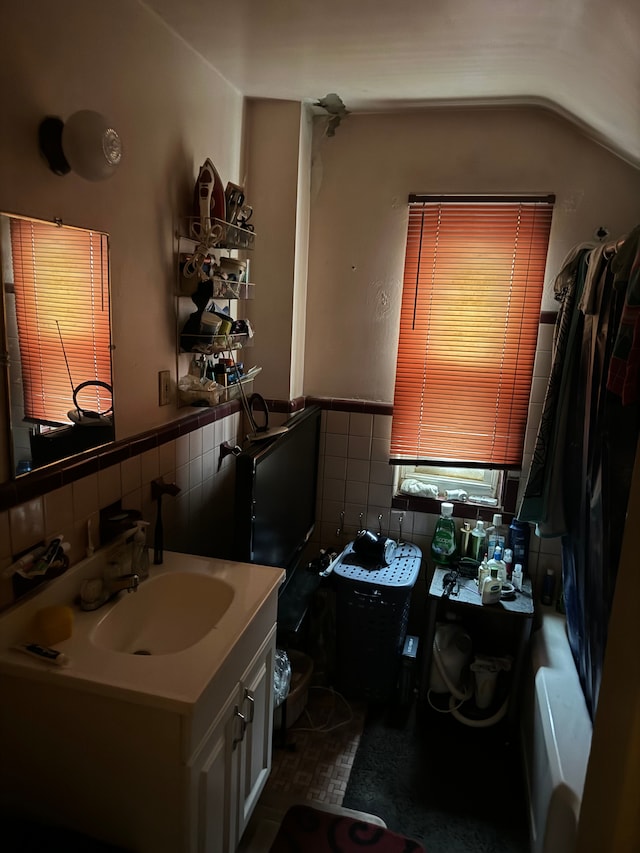 bathroom with vanity and vaulted ceiling