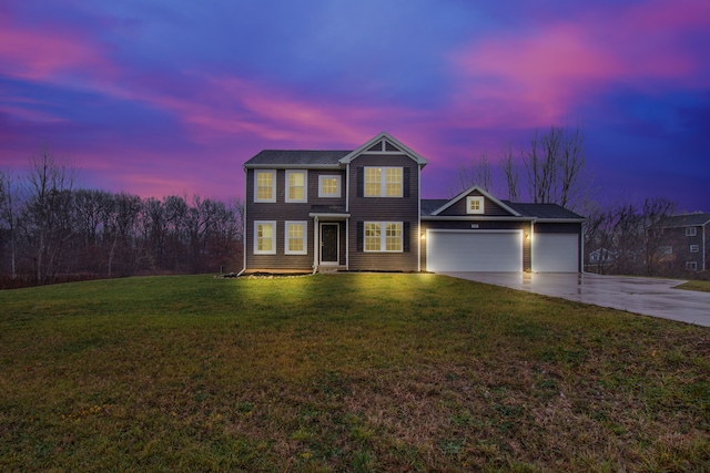 view of front of home featuring a garage and a yard