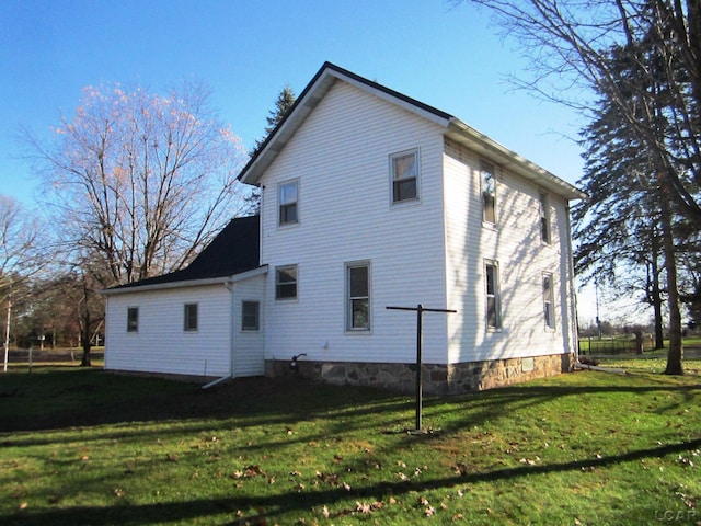 rear view of house with a lawn