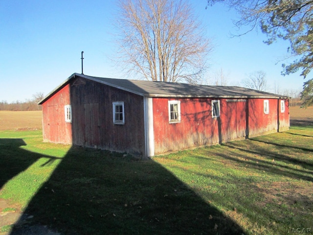 view of outbuilding featuring a lawn