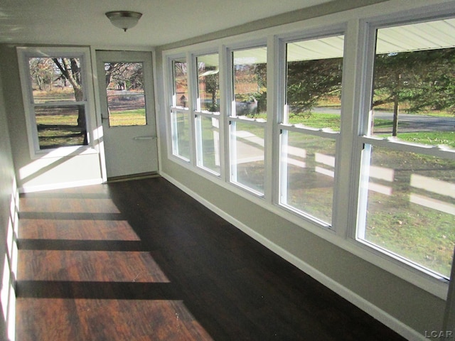 16378 Cadmus Rd, Hudson, MI 49247 - unfurnished sunroom featuring baseboards and wood finished floors