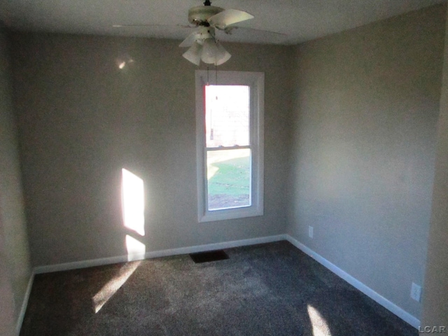 carpeted spare room with ceiling fan