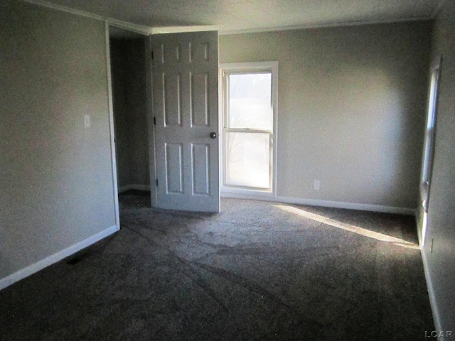 unfurnished room featuring carpet floors and ornamental molding