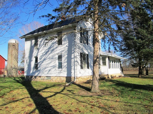 view of property exterior with a lawn