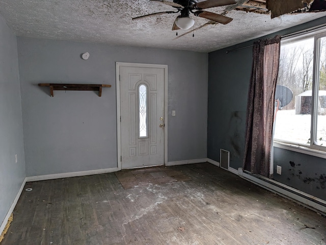 foyer entrance with hardwood / wood-style flooring, ceiling fan, and a textured ceiling