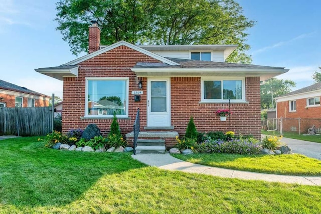 bungalow-style home with a front lawn