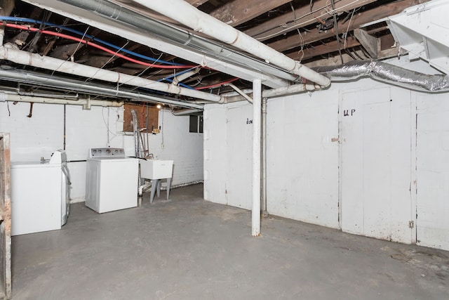 basement featuring washer and dryer and sink