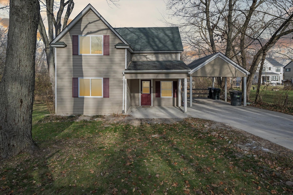 exterior space featuring covered porch and a yard