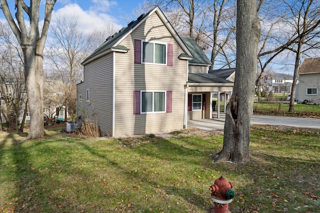 exterior space with a lawn and central air condition unit