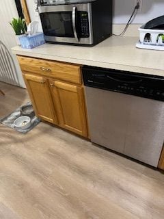 kitchen featuring stainless steel appliances and light hardwood / wood-style floors