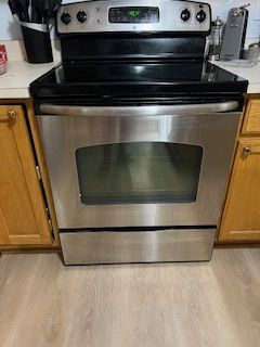 interior details with light hardwood / wood-style floors and electric range