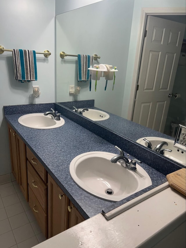 bathroom featuring tile patterned flooring and vanity