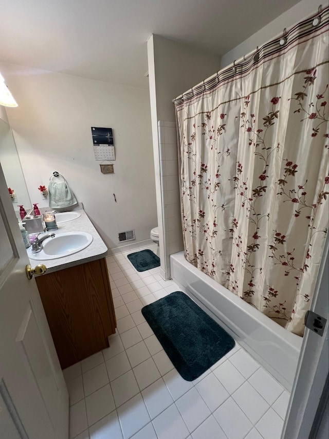 full bathroom with vanity, toilet, tile patterned floors, and shower / bath combo with shower curtain