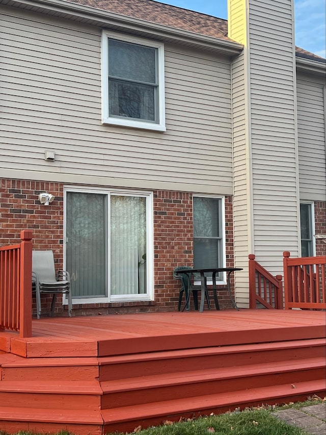 back of house featuring a wooden deck