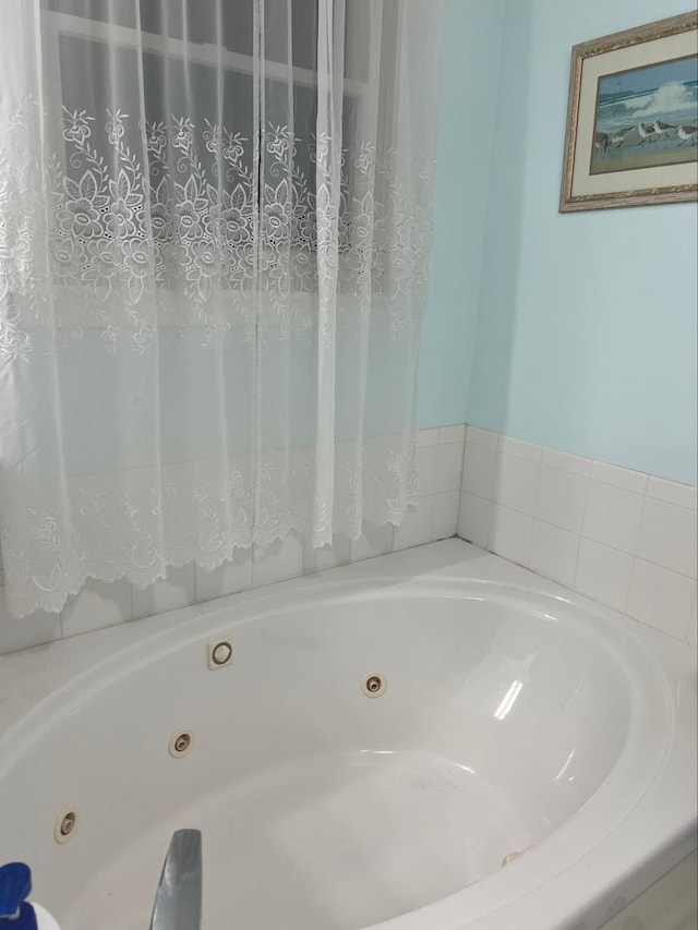 bathroom with tiled bath