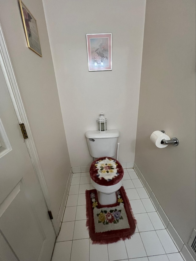 bathroom with tile patterned flooring and toilet