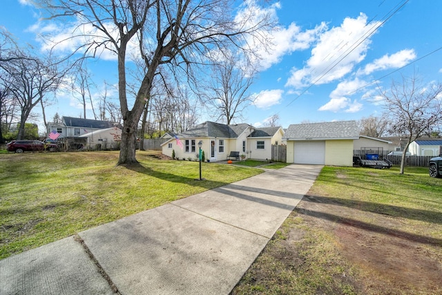 single story home with a front yard, a garage, and an outdoor structure