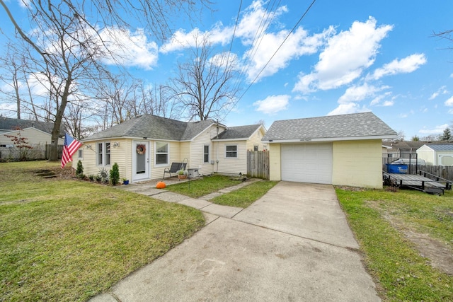 ranch-style house with an outbuilding, a garage, and a front lawn