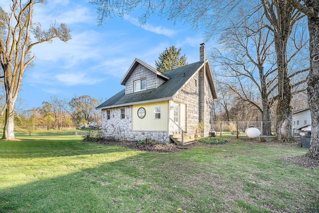 view of side of home with a yard