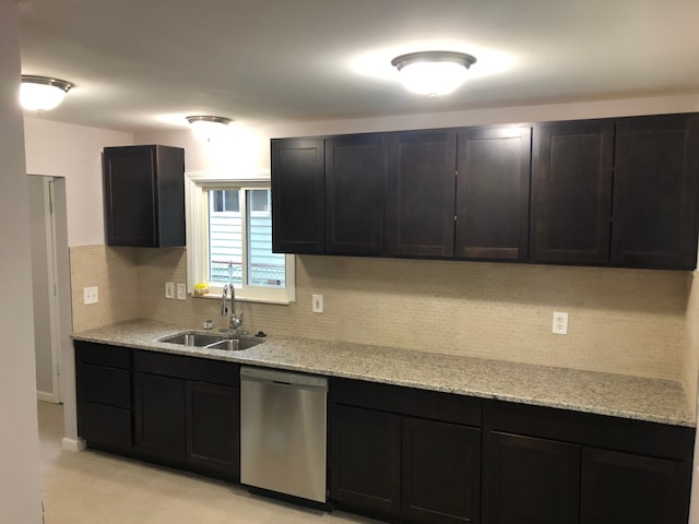 kitchen featuring dishwasher, light stone counters, sink, and tasteful backsplash