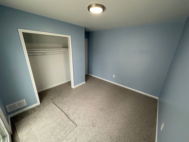 unfurnished bedroom with carpet and a closet